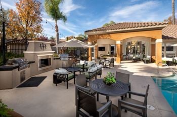 Patio with tables and chairs and a swimming pool
